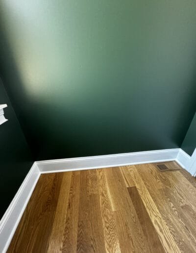 Walls painted in deep forest green for a cozy bathroom