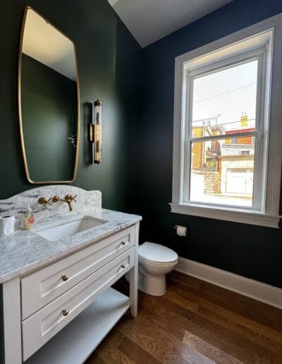 Elegant forest green bathroom with gold accents