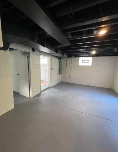 White walls contrasting with grey basement floor