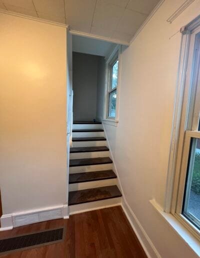 Staircase walls repainted in light gray tones