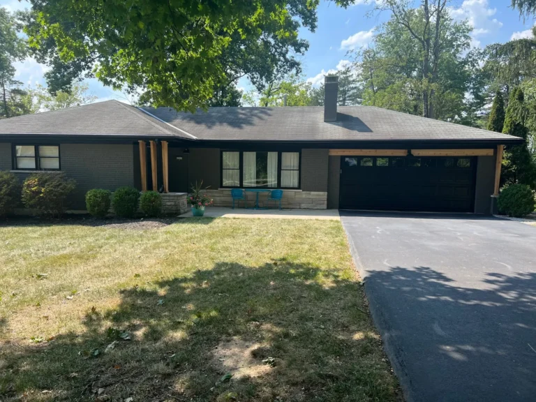 Brick ranch exterior painted charcoal-black — Bishop Elite Painting