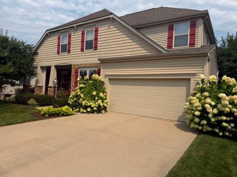 Two-story home in Eastgate, OH with exterior trim and garage door repainted in Sherwin-Williams Tavern Taupe