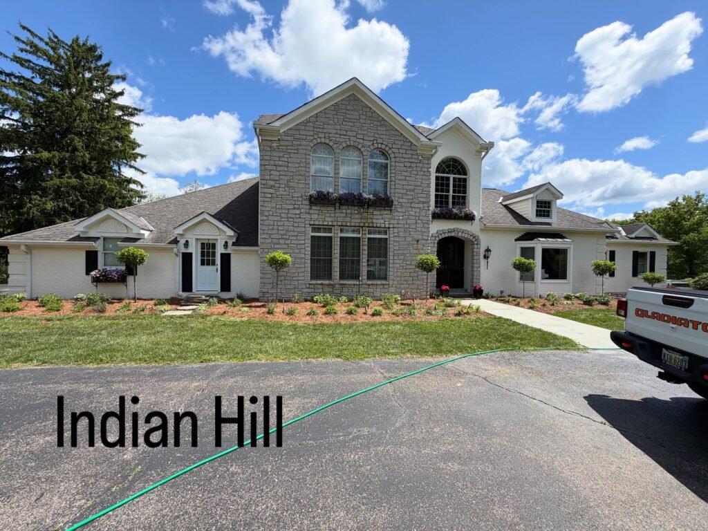 Finished exterior in Indian Hill, OH with soft white painted brick, black shutters and fresh landscaping